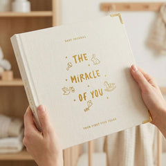 ZICOTO baby memory book with linen cover for lasting milestones.