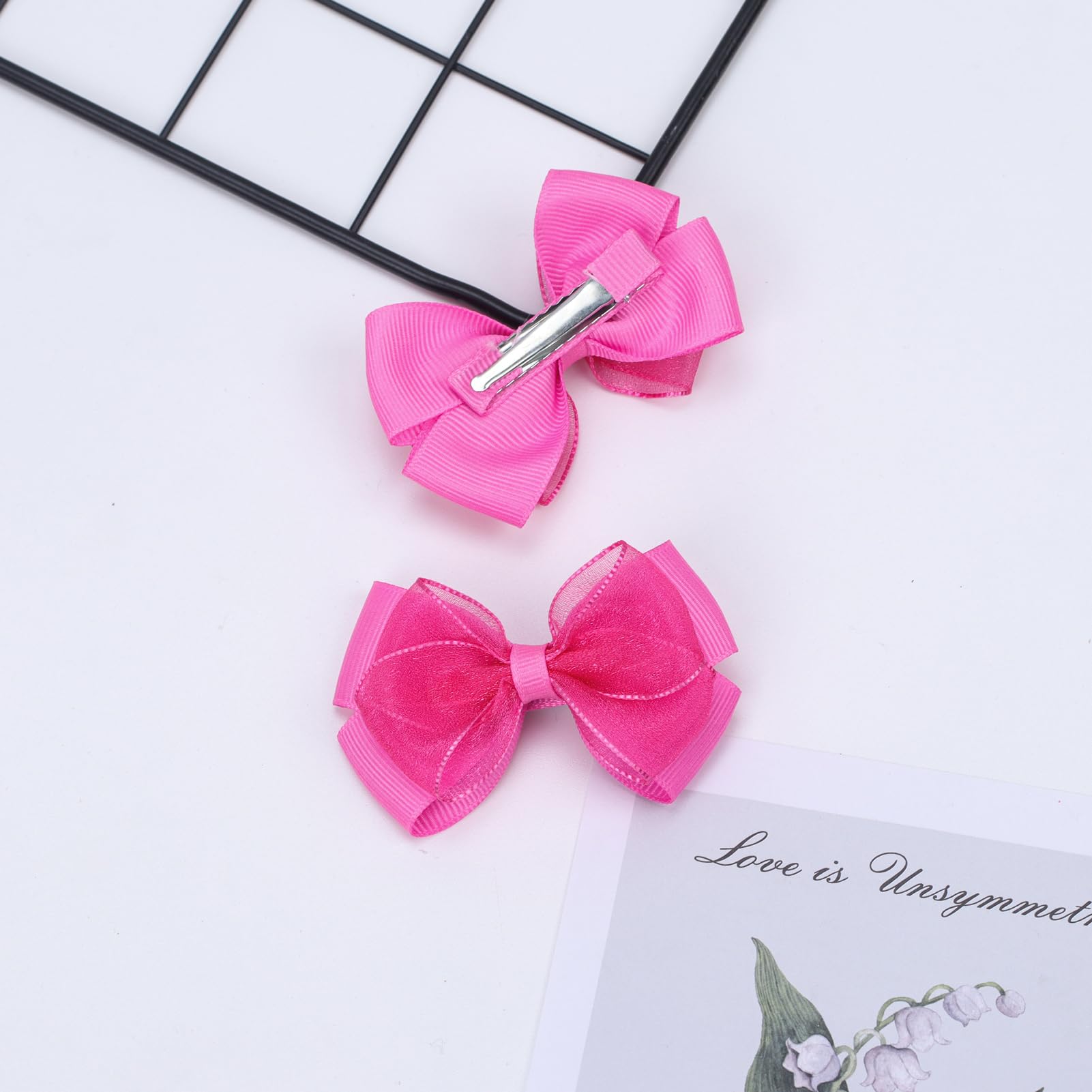 Zolyco double-bow clip showcases half-wrap cloth edge design.