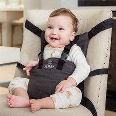 Zomee travel highchair universal fit secures seating on most chairs.