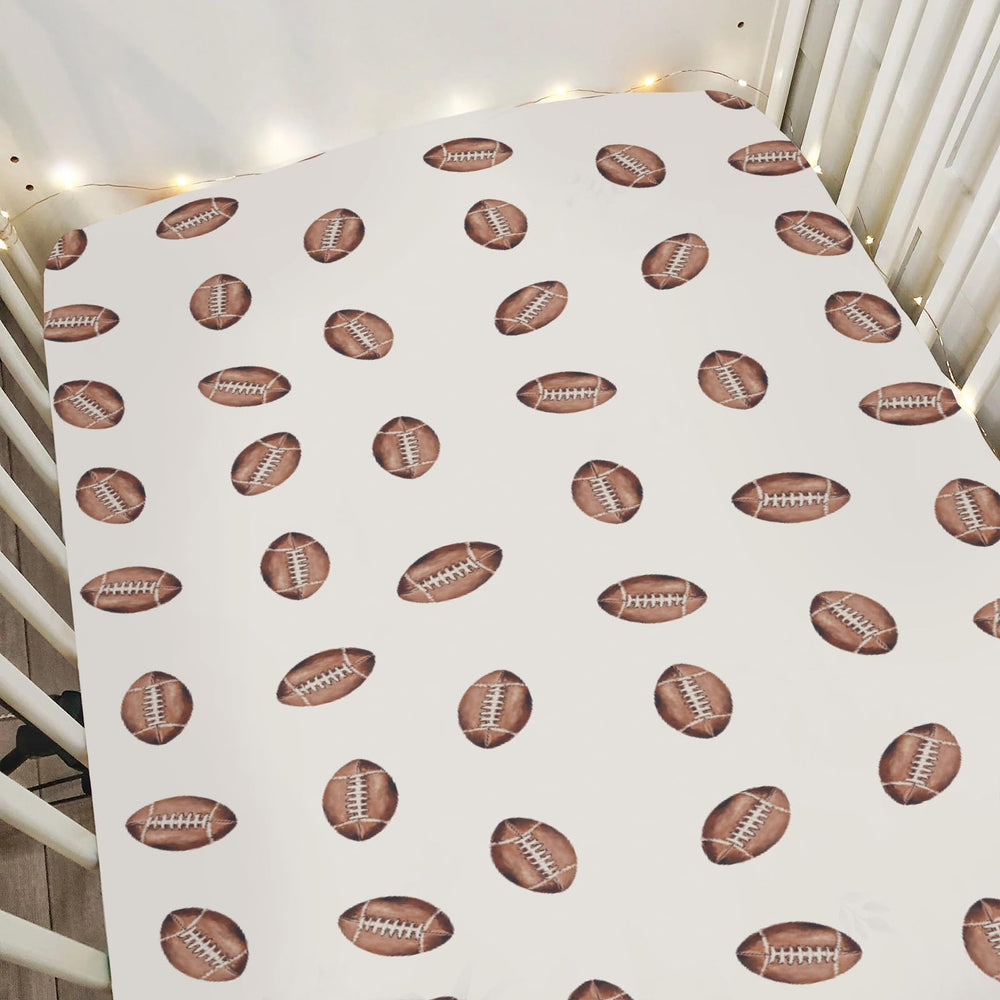 ZoUbqchY cream watercolor footballs crib sheet fits standard cribs for secure sleep.