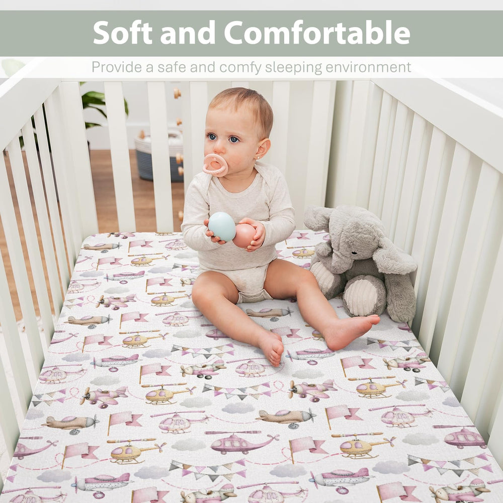ZoUbqchY watercolor pink helicopters crib sheet enhances unisex nursery decor.