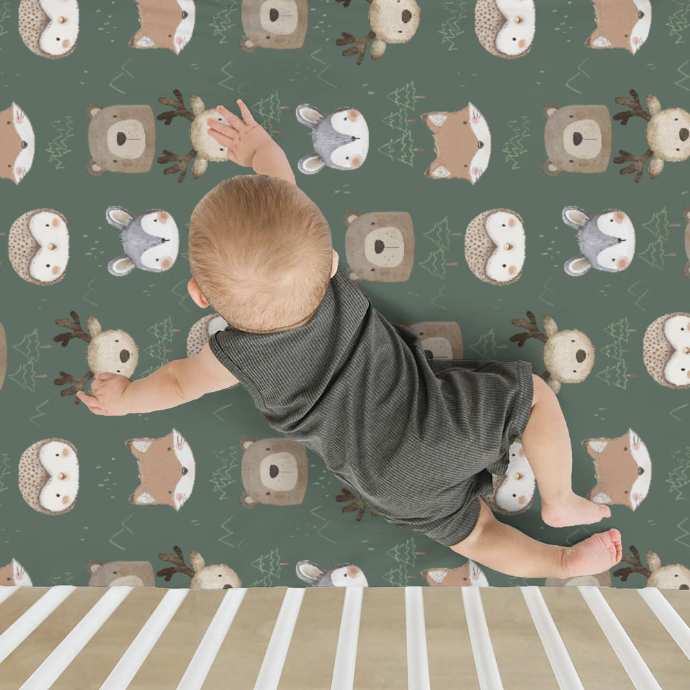 ZoUbqchY green-forest crib sheet blends with various decor styles.