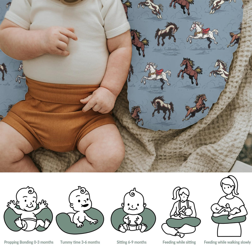 ZoUbqchY blue nursing cover displayed with pillows in a nursery setup.