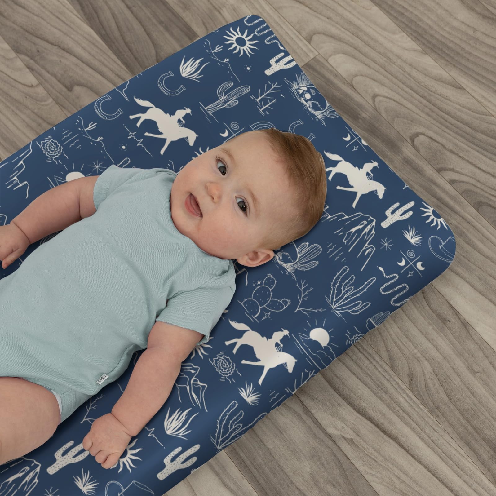 Zoubqchy wild west design on changing pad cover coordinates with theme.