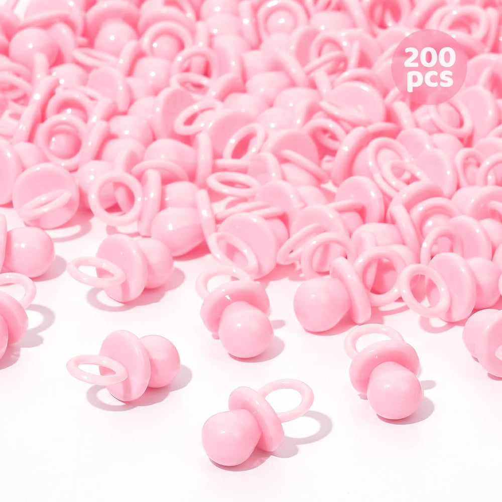 ZYFLSQ pink 200 mini pacifiers scattered on a table for baby shower decor