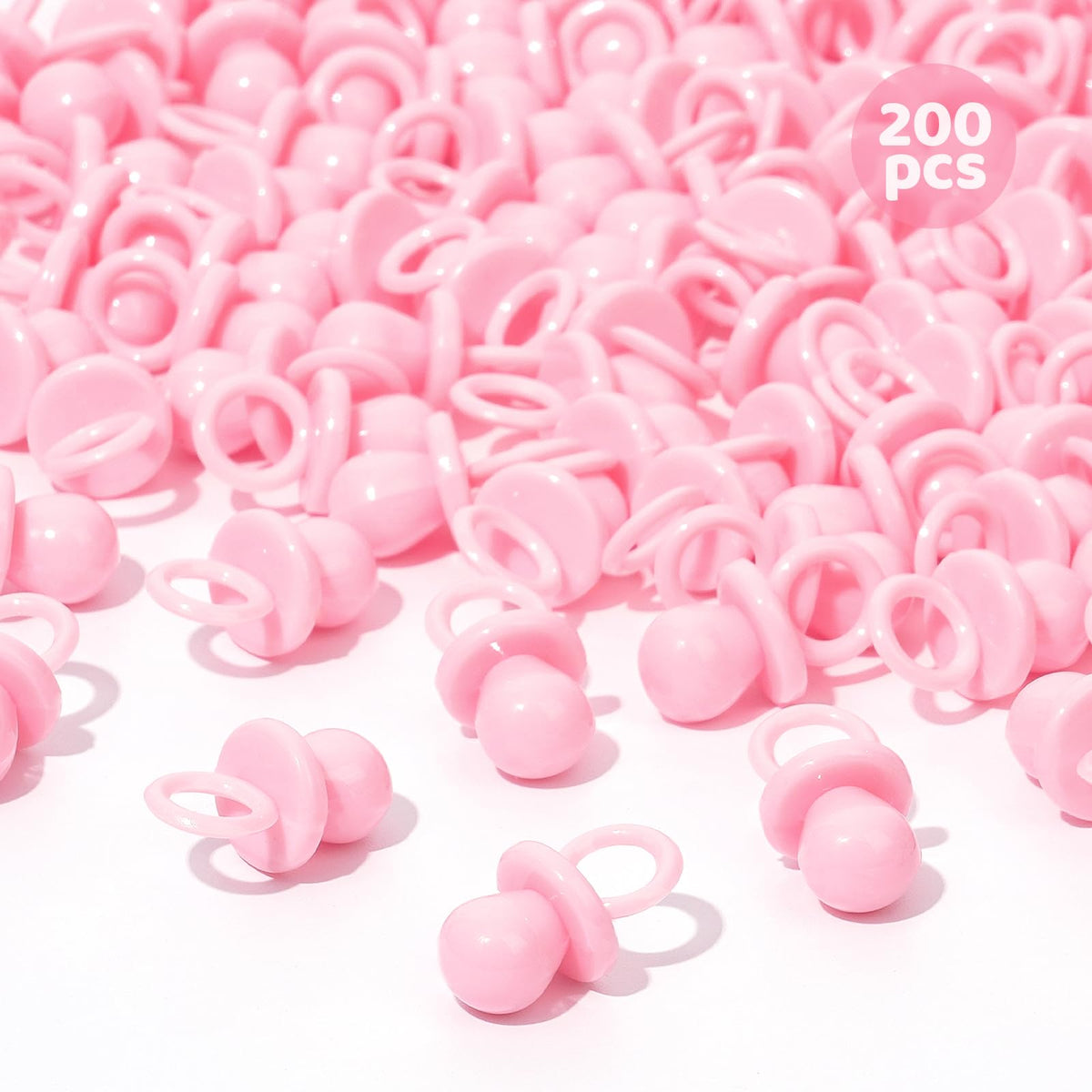 ZYFLSQ pink 200 mini pacifiers scattered on a table for baby shower decor